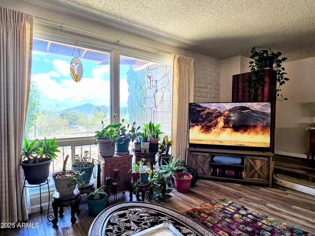 a living room with fireplace furniture and a flat screen tv