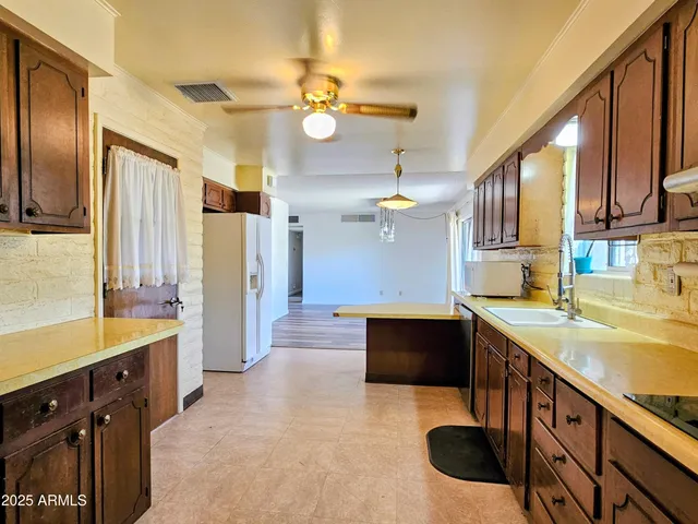 a kitchen with stainless steel appliances granite countertop a sink and a refrigerator