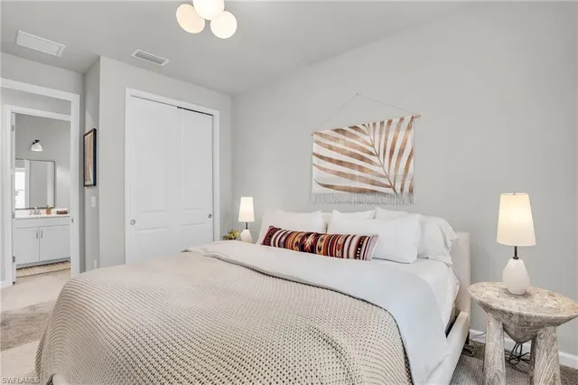 a bedroom with a bed and a lamp