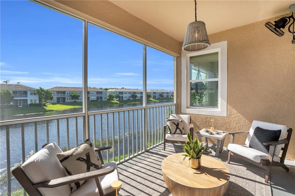 4595 Arboretum Circle, Unit 203 Naples, FL 34112 - Photo 14 of 22 a dining room with furniture a chandelier and windows