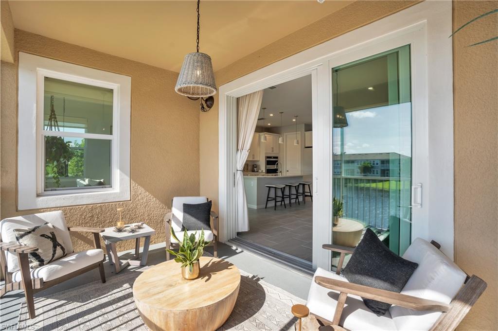 4595 Arboretum Circle, Unit 203 Naples, FL 34112 - Photo 15 of 22 a living room with furniture and a window