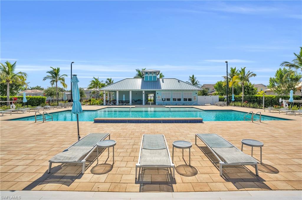 4595 Arboretum Circle, Unit 203 Naples, FL 34112 - Photo 19 of 22 a view of a patio with a table and chairs