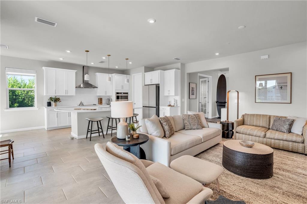 4595 Arboretum Circle, Unit 203 Naples, FL 34112 - Photo 2 of 22 a living room with furniture and a large window