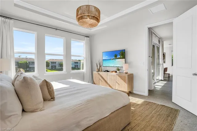 a spacious bedroom with a large bed and a large window