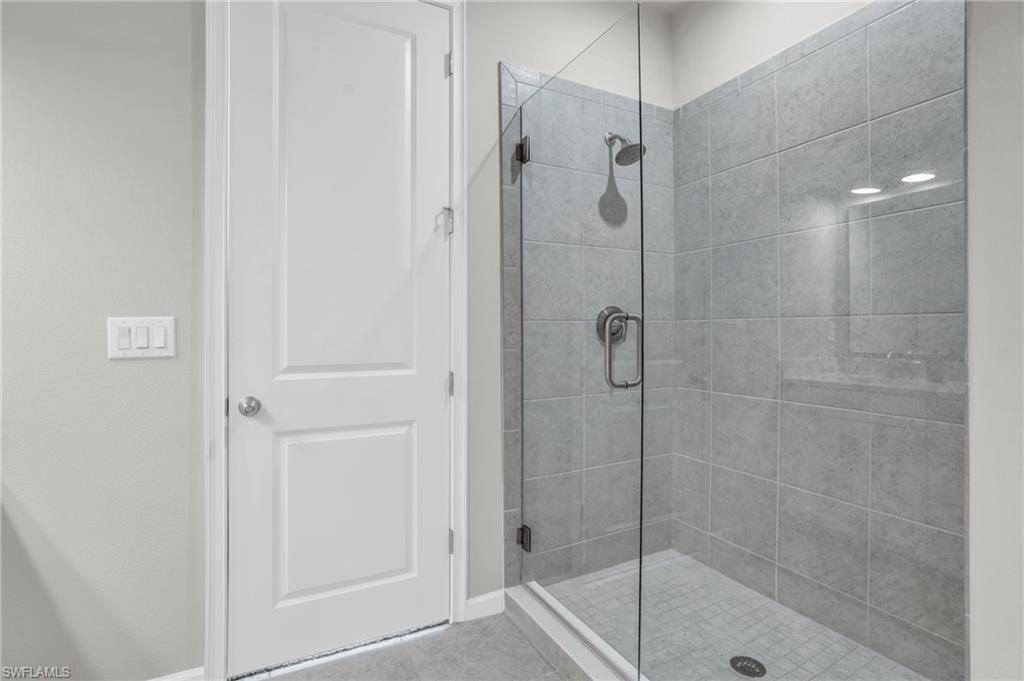 4595 Arboretum Circle, Unit 203 Naples, FL 34112 - Photo 8 of 22 a bathroom with a shower