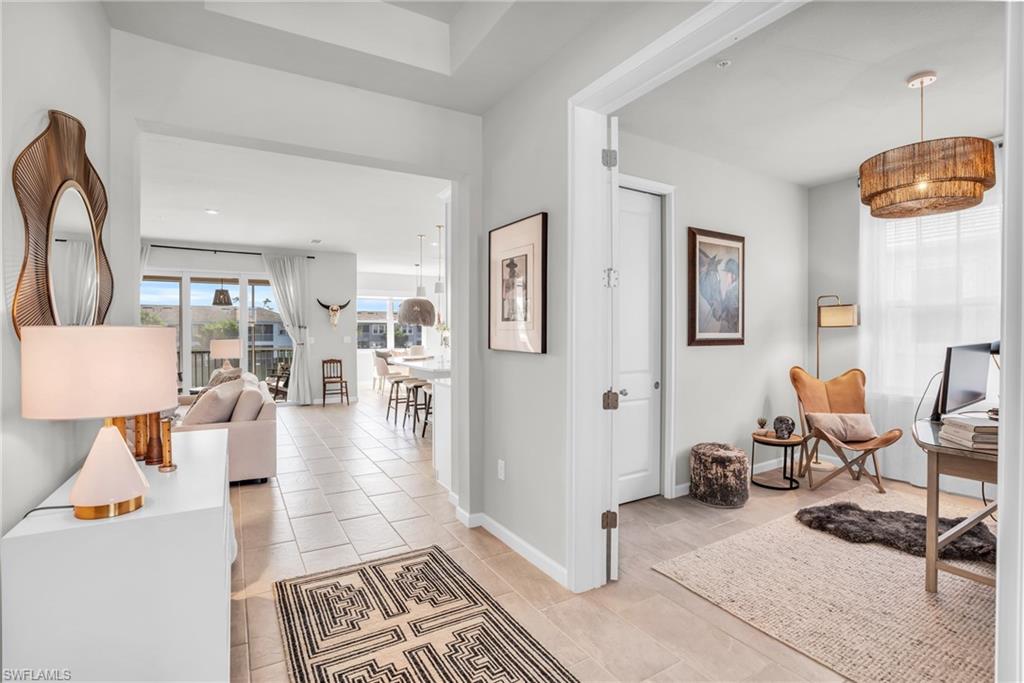 4595 Arboretum Circle, Unit 203 Naples, FL 34112 - Photo 10 of 22 a living room with furniture and a table