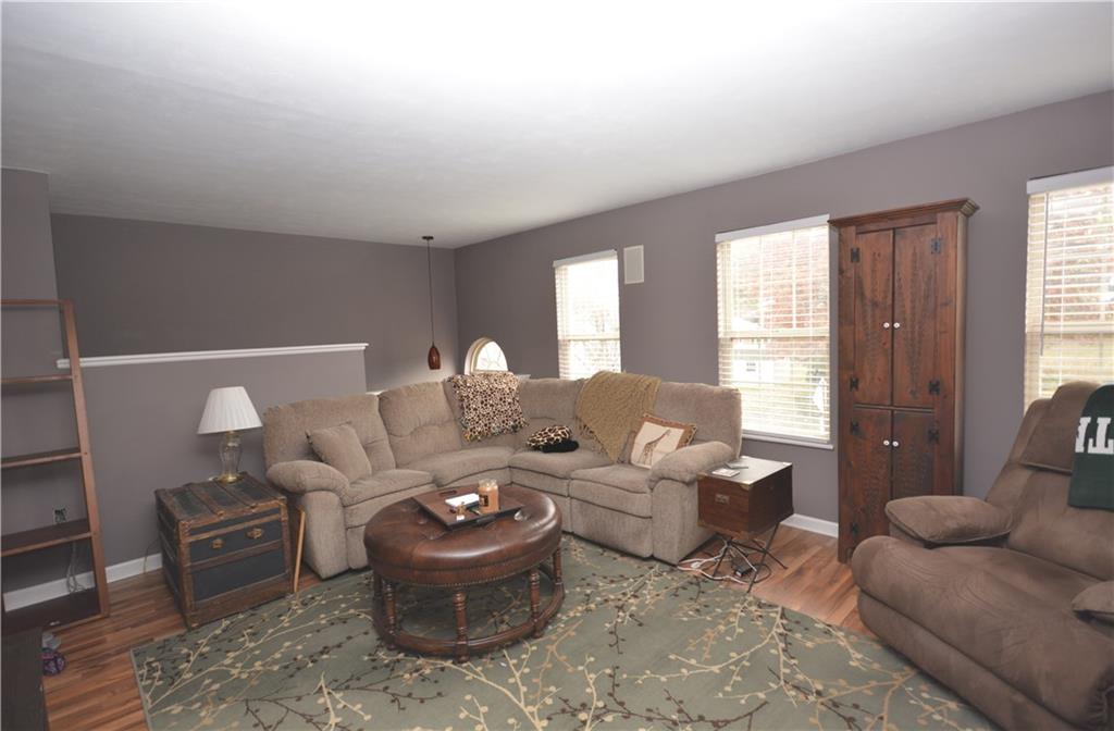 218 Grace Street McKees Rocks, PA 15136 - Photo 3 of 22 Open living room features plantation blinds and built-in speakers. Laminate flooring throughout main floor.