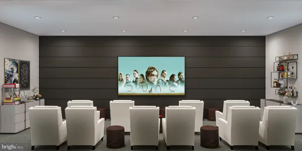 a living room with furniture and wall paintings