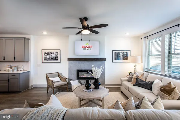 a living room with furniture kitchen view and a fireplace