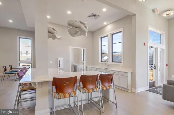 a dining room with furniture window and wooden floor