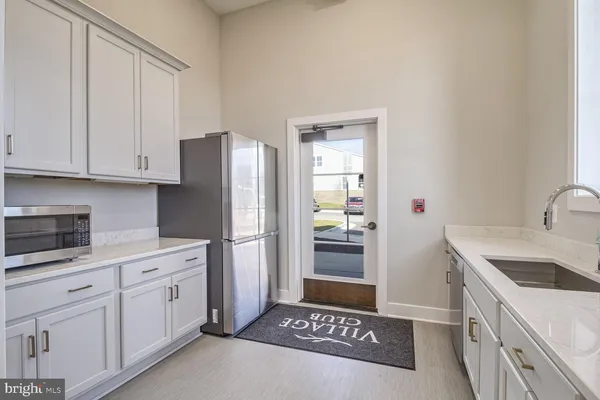 a large white kitchen with a large window