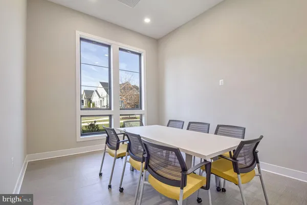 a living room with furniture a rug and a large window