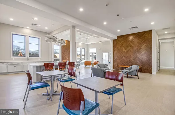 a view of house with a big yard and potted plants