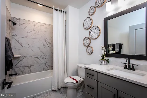 a bathroom with a sink a toilet and a bathtub
