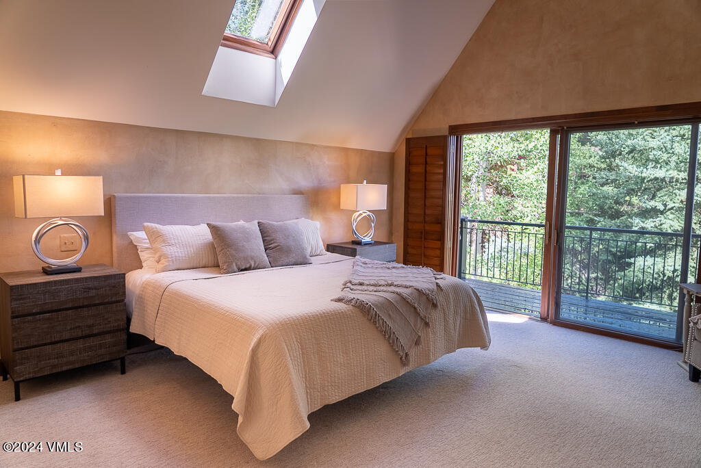 850 Eagle Drive Eagle-Vail, CO 81620 - Photo 11 of 32 a bedroom with a bed and a large window