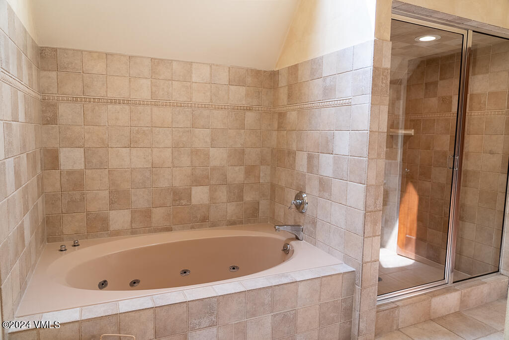 850 Eagle Drive Eagle-Vail, CO 81620 - Photo 13 of 32 a bathroom with a bathtub and shower