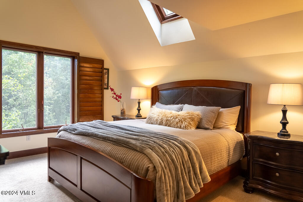 850 Eagle Drive Eagle-Vail, CO 81620 - Photo 20 of 32 a bedroom with a bed and a lamp on dresser