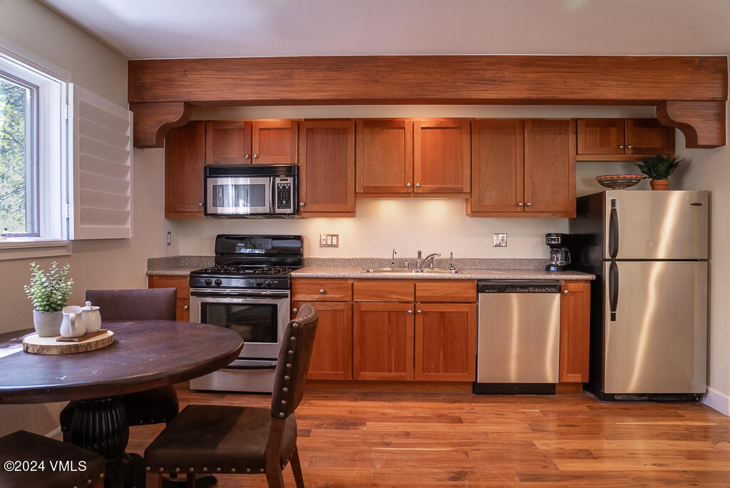 850 Eagle Drive Eagle-Vail, CO 81620 - Photo 23 of 32 a kitchen with stainless steel appliances granite countertop a refrigerator a stove a sink and a white cabinets