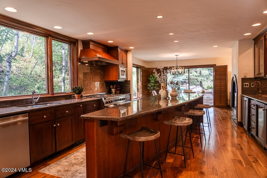 850 Eagle Drive Eagle-Vail, CO 81620 - Photo 6 of 32 a kitchen with stainless steel appliances a sink table and chairs