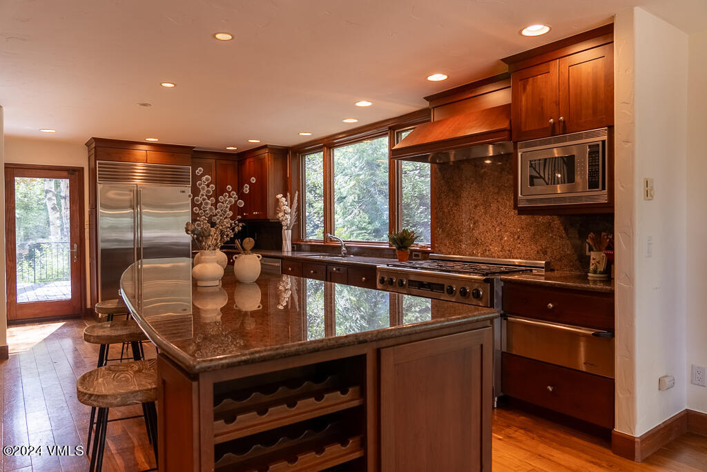 850 Eagle Drive Eagle-Vail, CO 81620 - Photo 7 of 32 a kitchen with stainless steel appliances granite countertop a sink and a stove