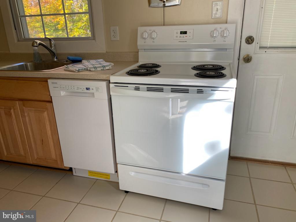 6909 Quander Road Alexandria, VA 22307 - Photo 16 of 36 KITCHEN WITH NEW STOVE AND DOOR TO BACKYARD DECK