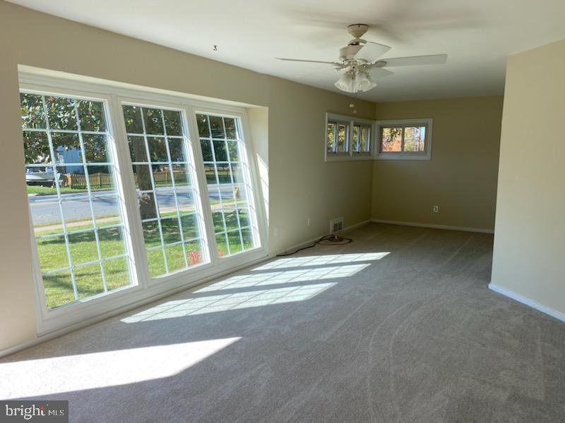 6909 Quander Road Alexandria, VA 22307 - Photo 7 of 36 SUNNY LIVING ROOM W/CEILING FAN AND NEW CARPET