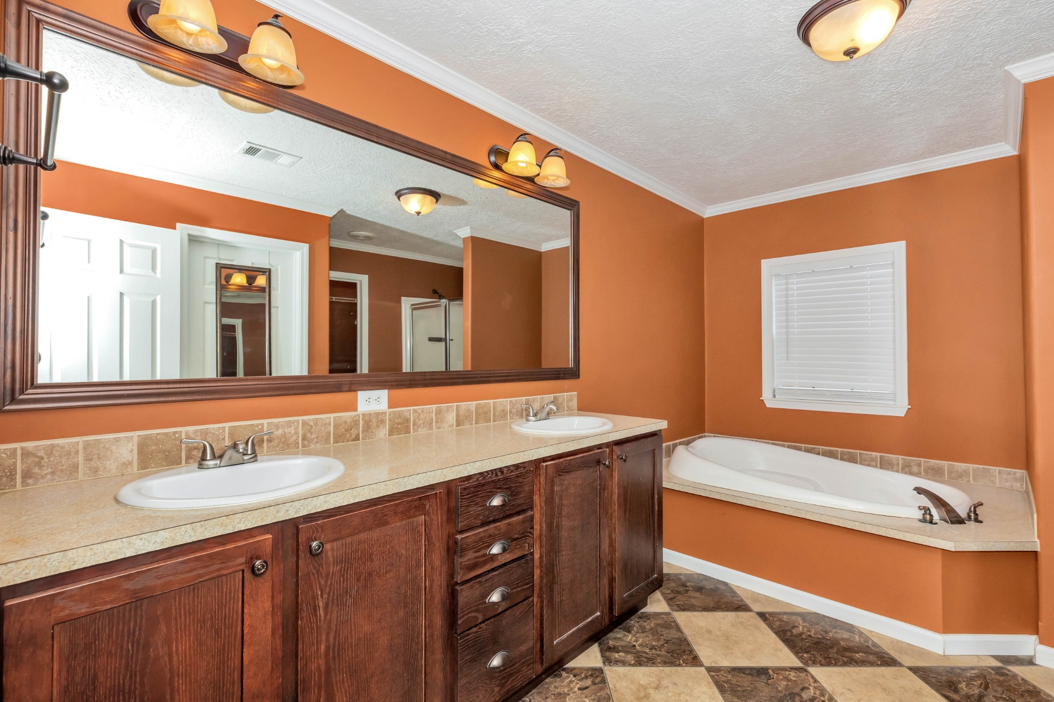 911 Poplar Hill Road Prospect, TN 38477 - Photo 14 of 33 a bathroom with a granite countertop double vanity sink and mirror with bathtub