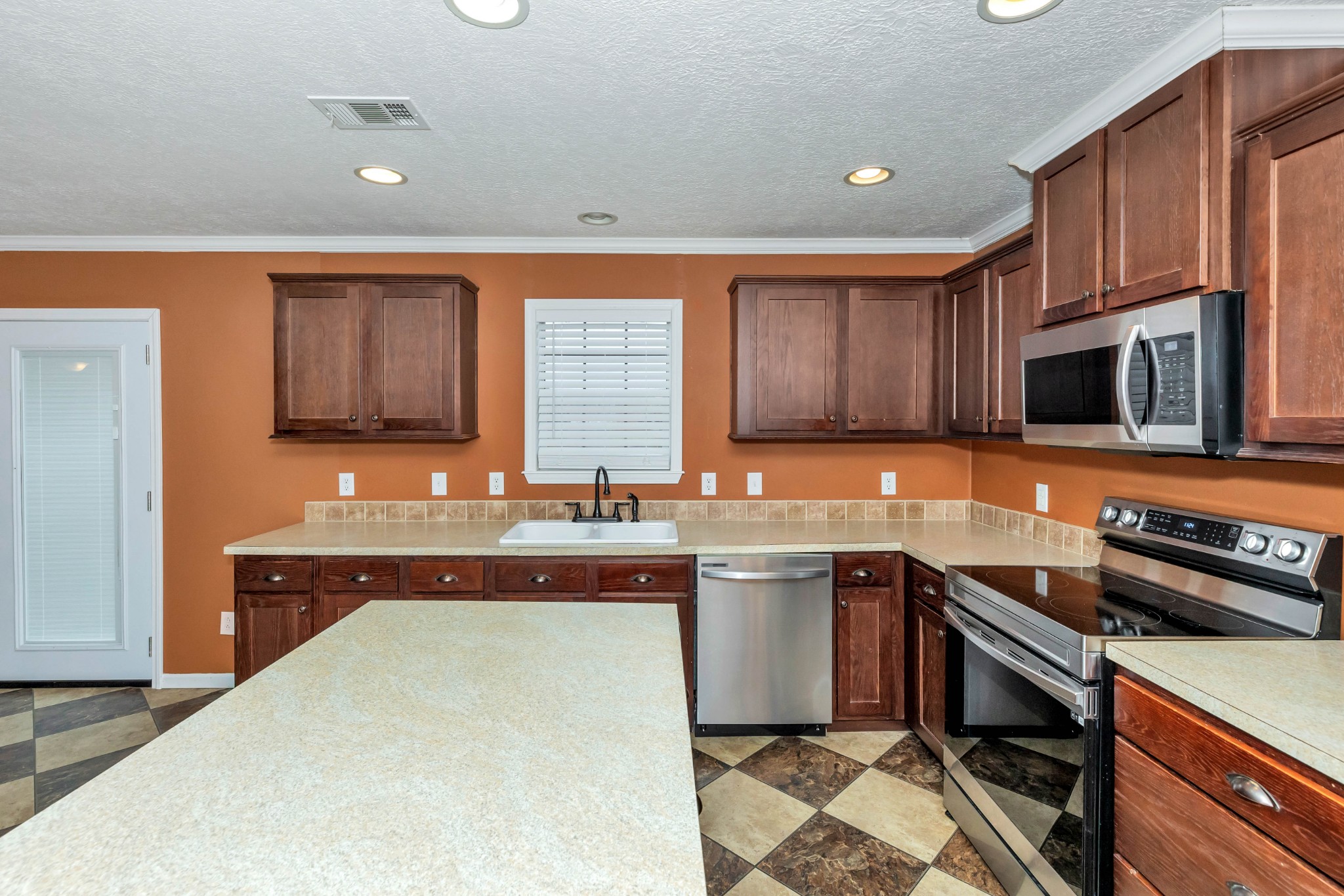 911 Poplar Hill Road Prospect, TN 38477 - Photo 7 of 33 a kitchen with stainless steel appliances a sink stove and microwave