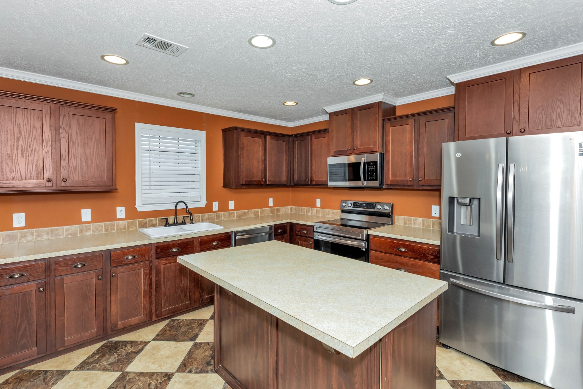 911 Poplar Hill Road Prospect, TN 38477 - Photo 8 of 33 a kitchen with stainless steel appliances granite countertop a refrigerator stove microwave and sink