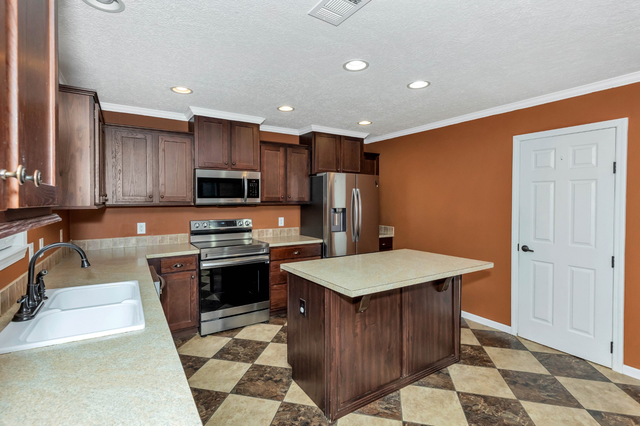 911 Poplar Hill Road Prospect, TN 38477 - Photo 9 of 33 a kitchen with stainless steel appliances granite countertop a sink stove and refrigerator