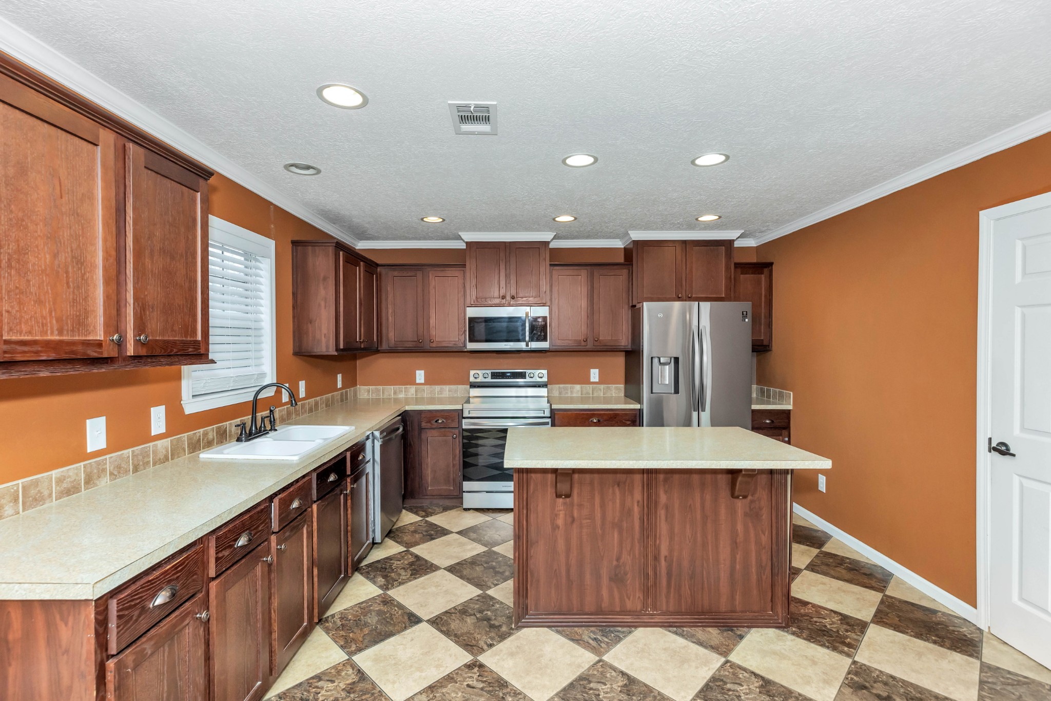 911 Poplar Hill Road Prospect, TN 38477 - Photo 10 of 33 a large kitchen with stainless steel appliances kitchen island granite countertop a sink refrigerator and cabinets