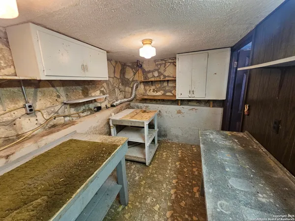 a kitchen with a stove a refrigerator and a sink