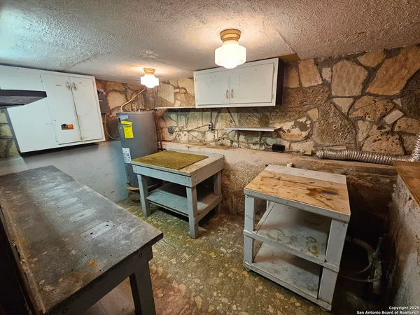 a kitchen with a stove and a wooden floor