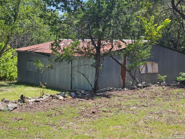 a view of a barn in the middle of a yard