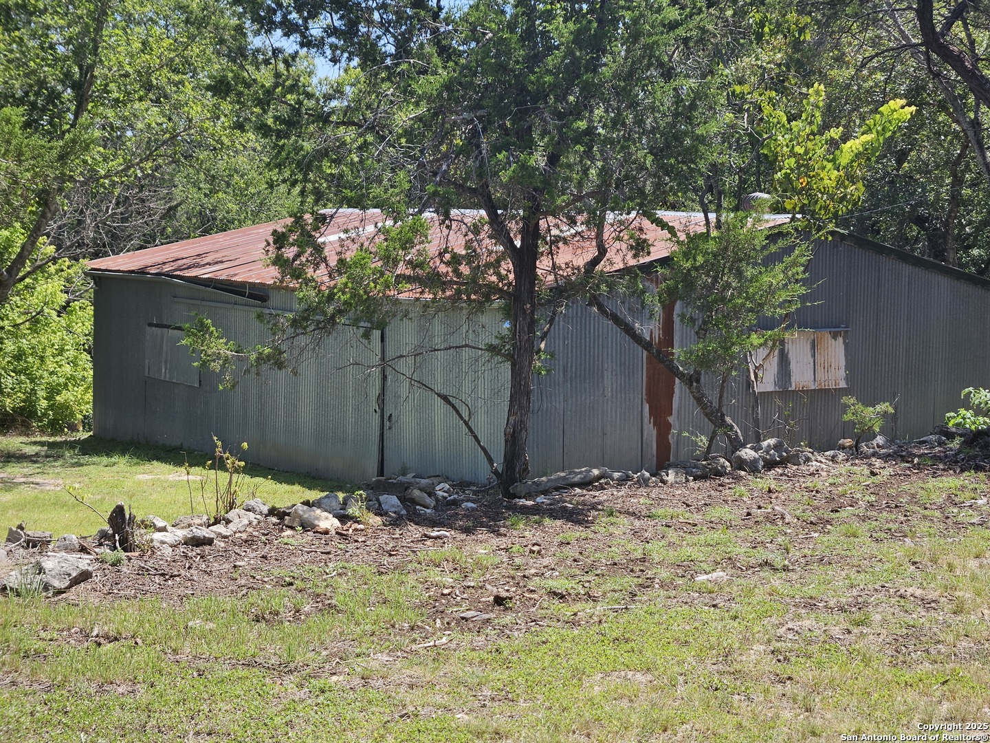 29 Green Cedar Road Boerne, TX 78006 - Photo 32 of 39 a view of a barn in the middle of a yard