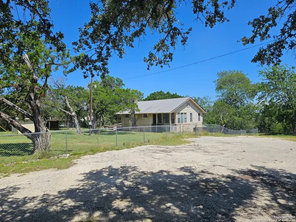 a view of big yard with a house in the background
