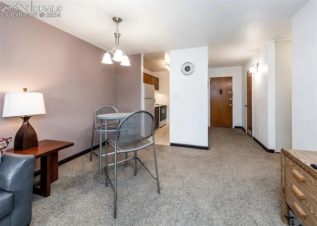 a view of a livingroom with furniture and a lamp
