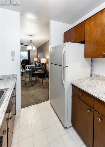 a kitchen with kitchen island a counter top space appliances and a view of living room