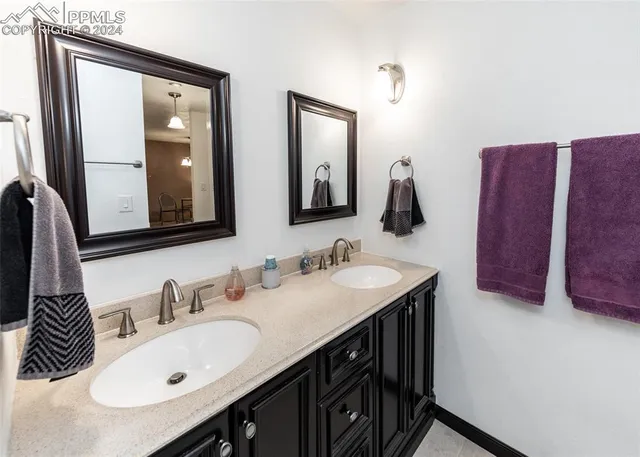 a bathroom with a double vanity sink and a mirror