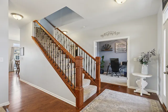 a view of entryway and hall with wooden floor