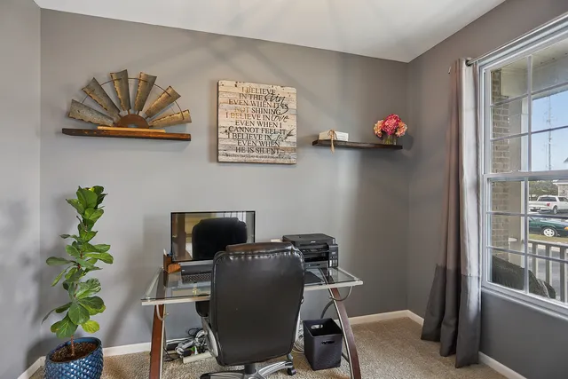 a view of a workspace with furniture and a potted plant