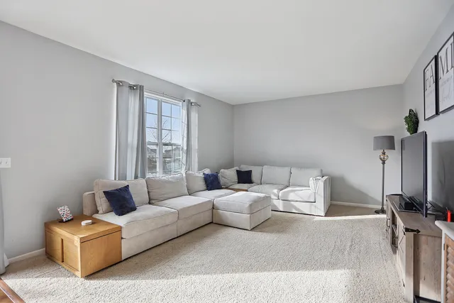 a living room with furniture window and a flat screen tv