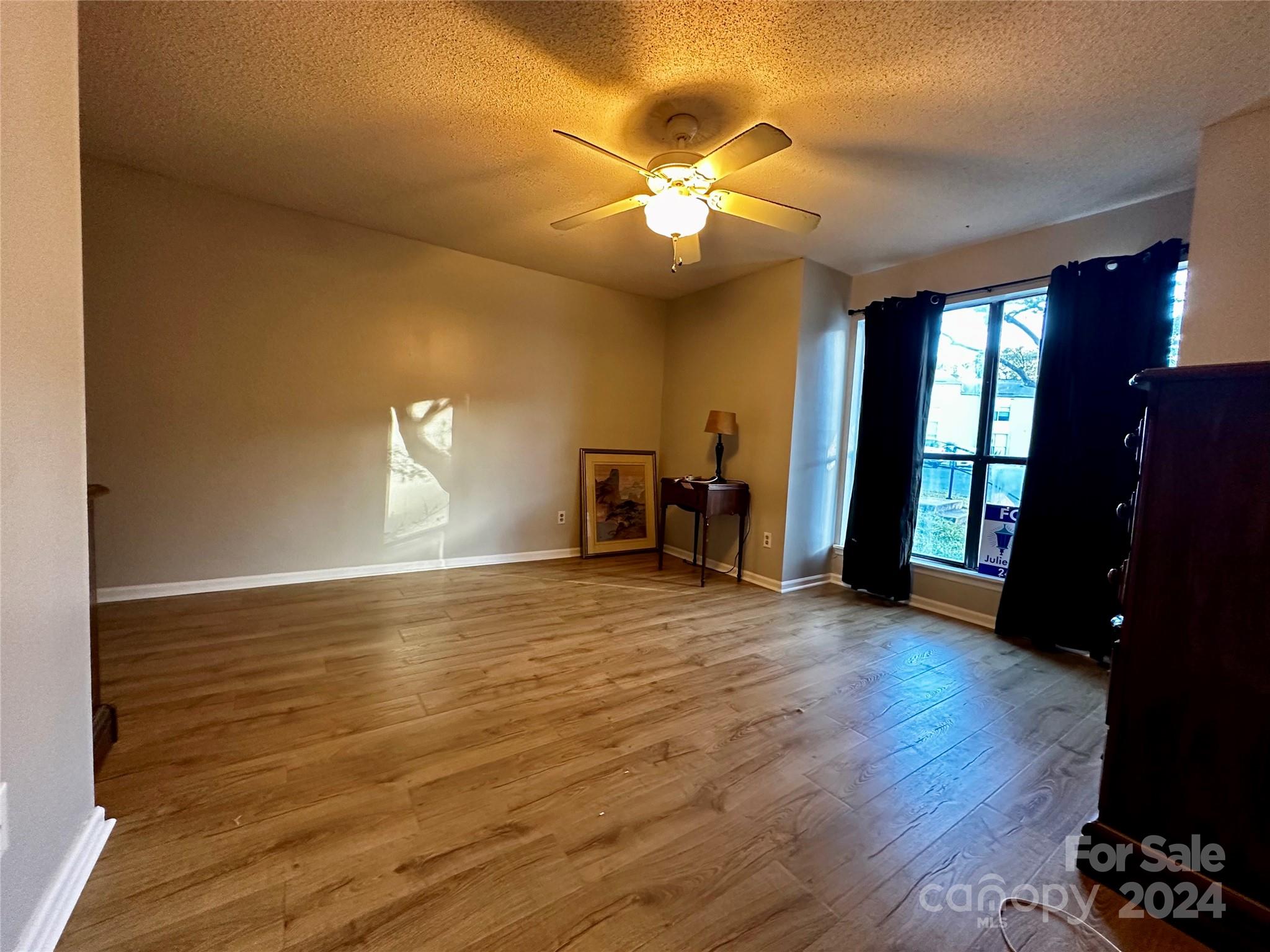 11015 Running Ridge Rd. Charlotte, NC 28226 - Photo 18 of 20 a view of empty room with wooden floor and fan