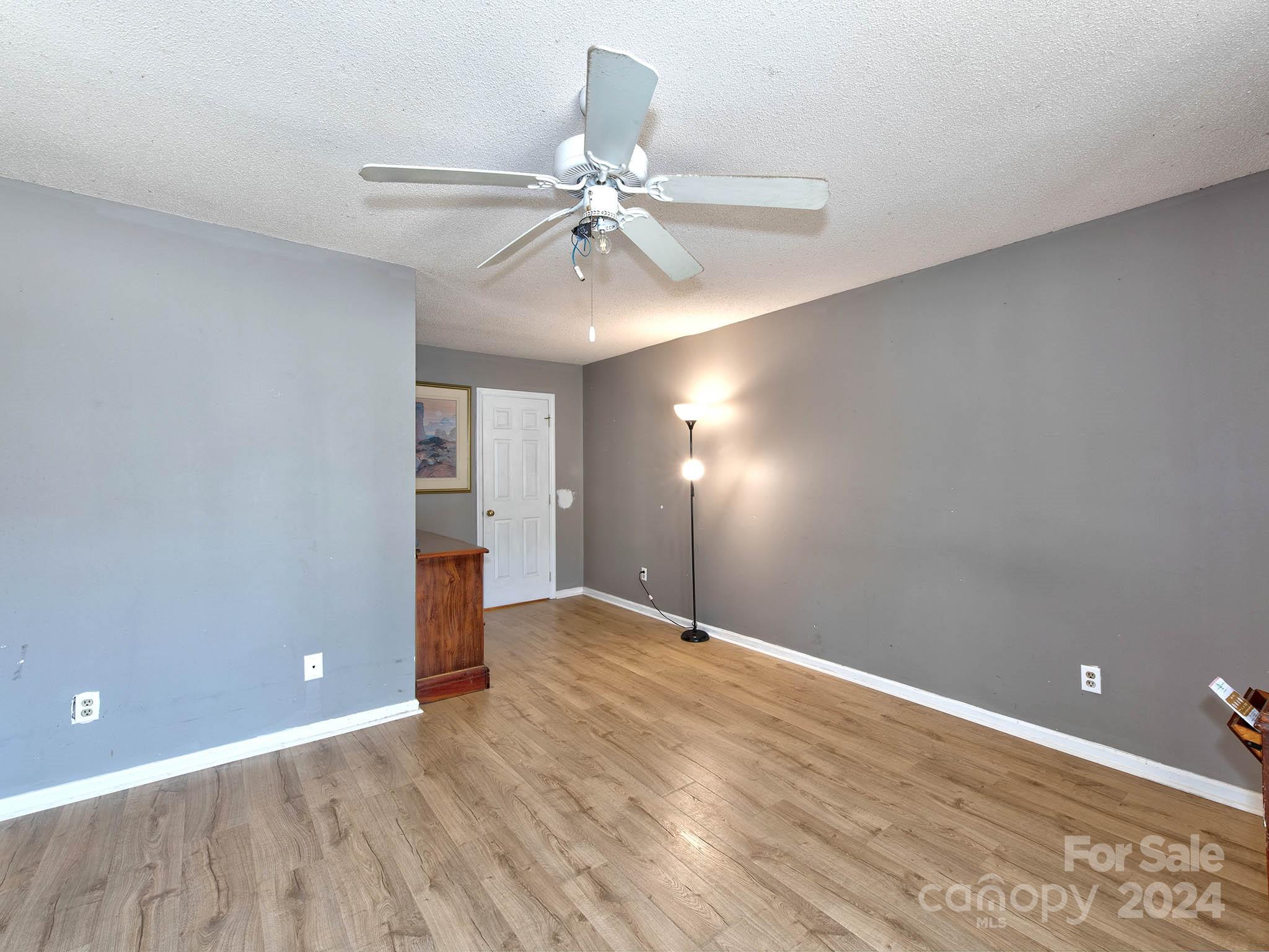 11015 Running Ridge Rd. Charlotte, NC 28226 - Photo 6 of 20 a view of an empty room with window and wooden floor