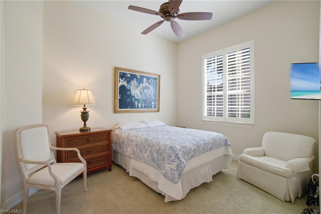 17015 Porta Vecchio Way, Unit 101 Naples, FL 34110 - Photo 16 of 39 a bedroom with a bed and a couch