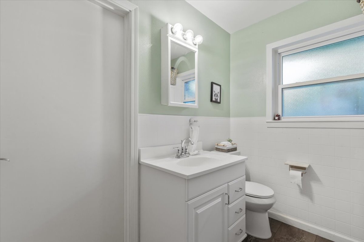 607 Short Street Smithville, TX 78957 - Photo 19 of 31 Bathroom featuring a single vanity with storage, white countertop, and integrated sink