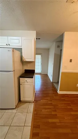 a room with a stove top oven and cabinets