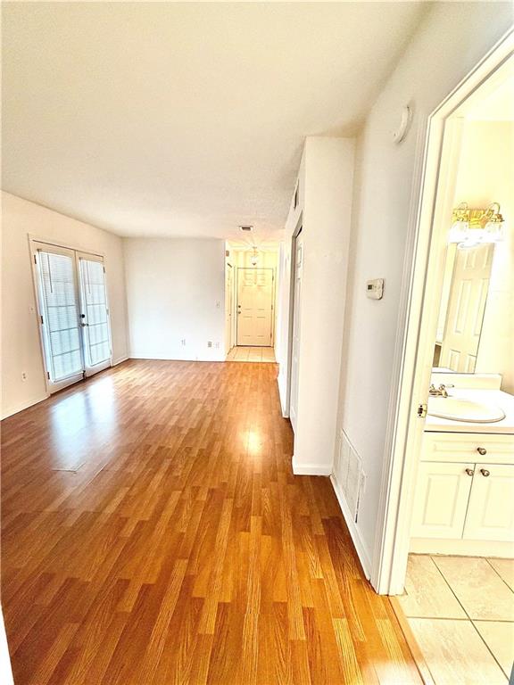 3595 Woodbriar Circle, Unit N Tucker, GA 30084 - Photo 18 of 39 a view of a big room with wooden floor and windows