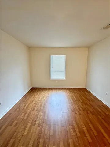 an entryway with wooden floor and cabinet