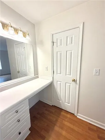 a bathroom with a sink mirror vanity and toilet